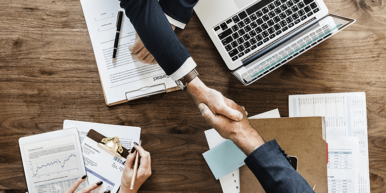 Two business men agreeing on something and shaking hands.